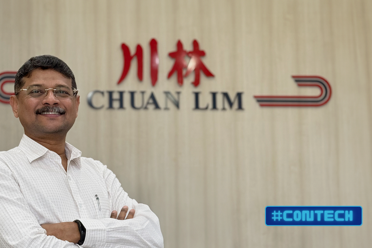 Portrait of construction professional standing before Chuan Lim company signage.